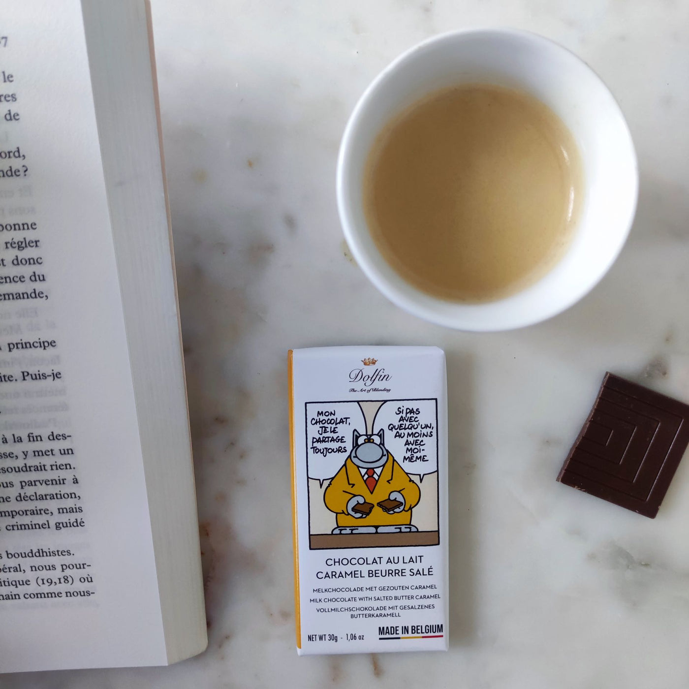 Savourez la mini tablette Dolfin x Le Chat de Philippe Geluck : chocolat au lait belge onctueux et caramel beurre salé, 30 g de douceur fondante et d’humour à croquer.
